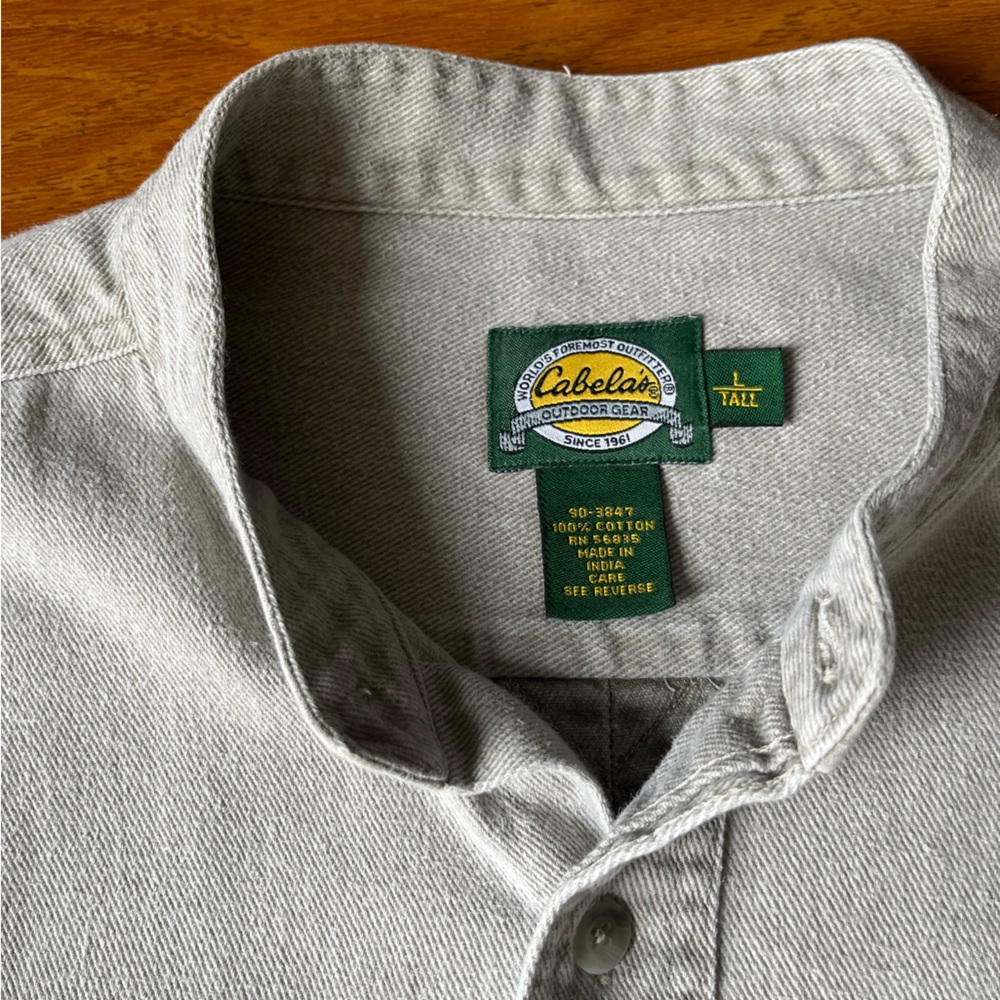 Silver, long sleeve, button down jacket from Cabela’s outdoor gear